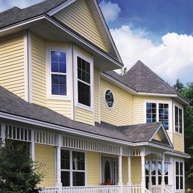 yellow house siding installed